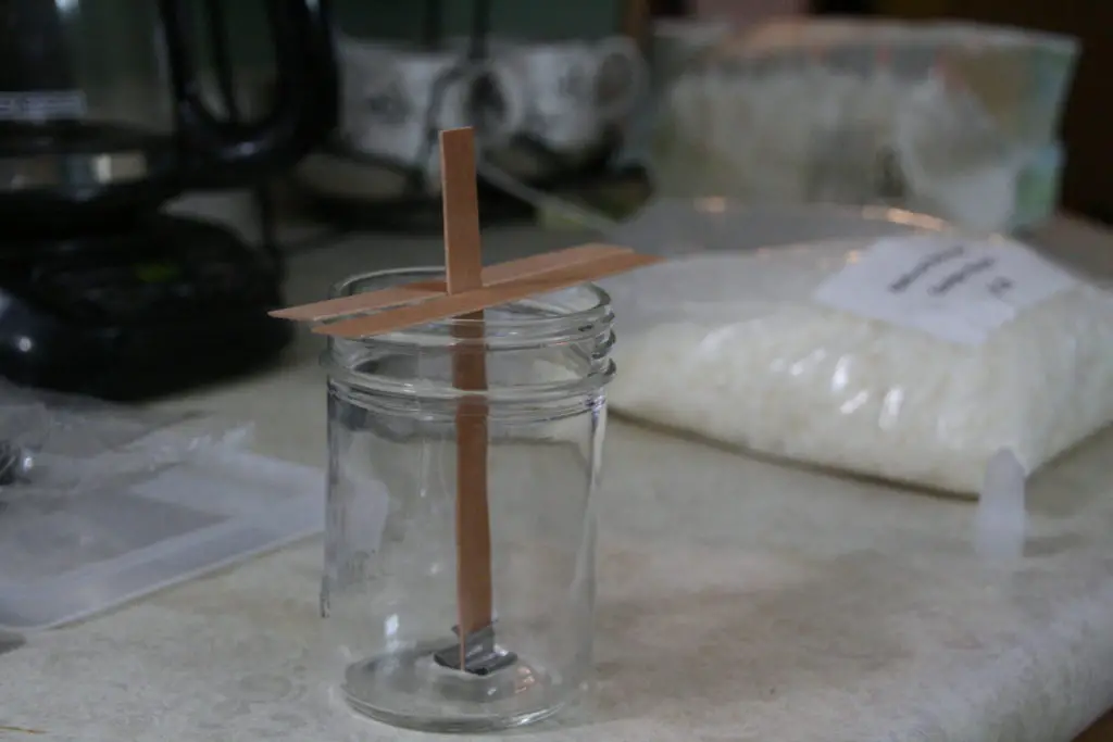 the mason jar is ready for the soy wax to be poured 