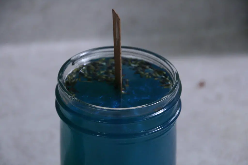 blue soy wax poured into the mason jar