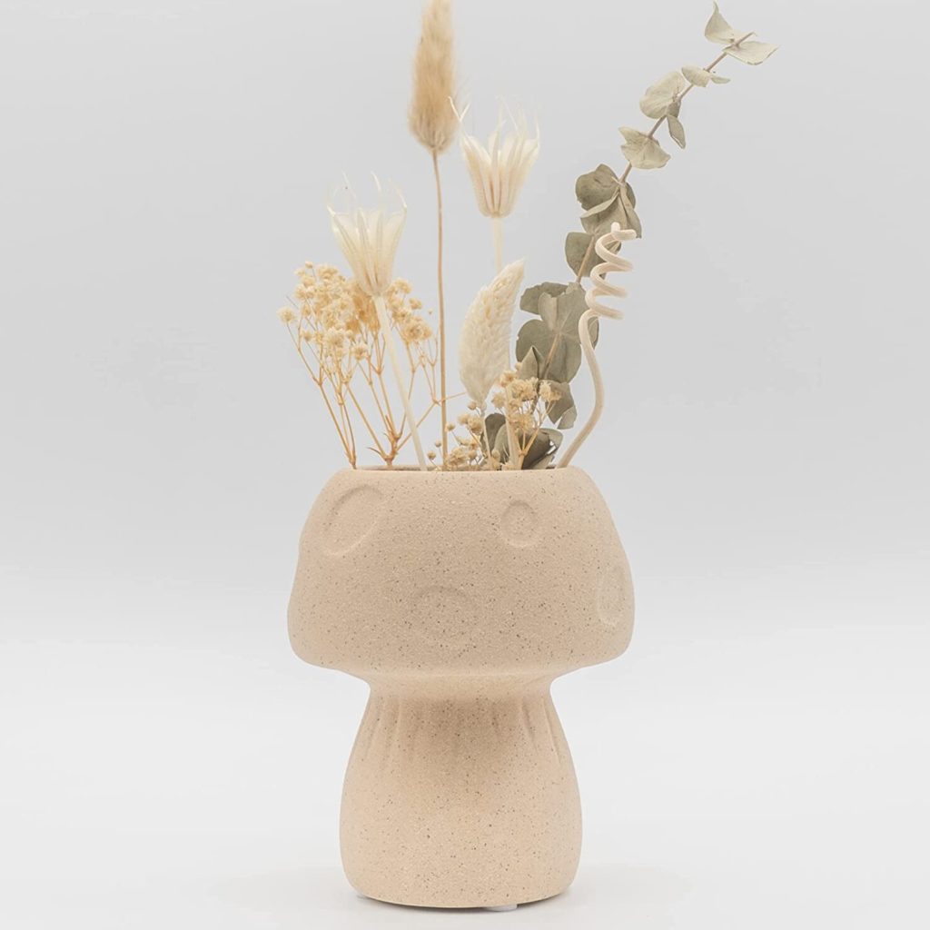 a cute cottagecore mushroom vase to decorate your bookshelf or personal library