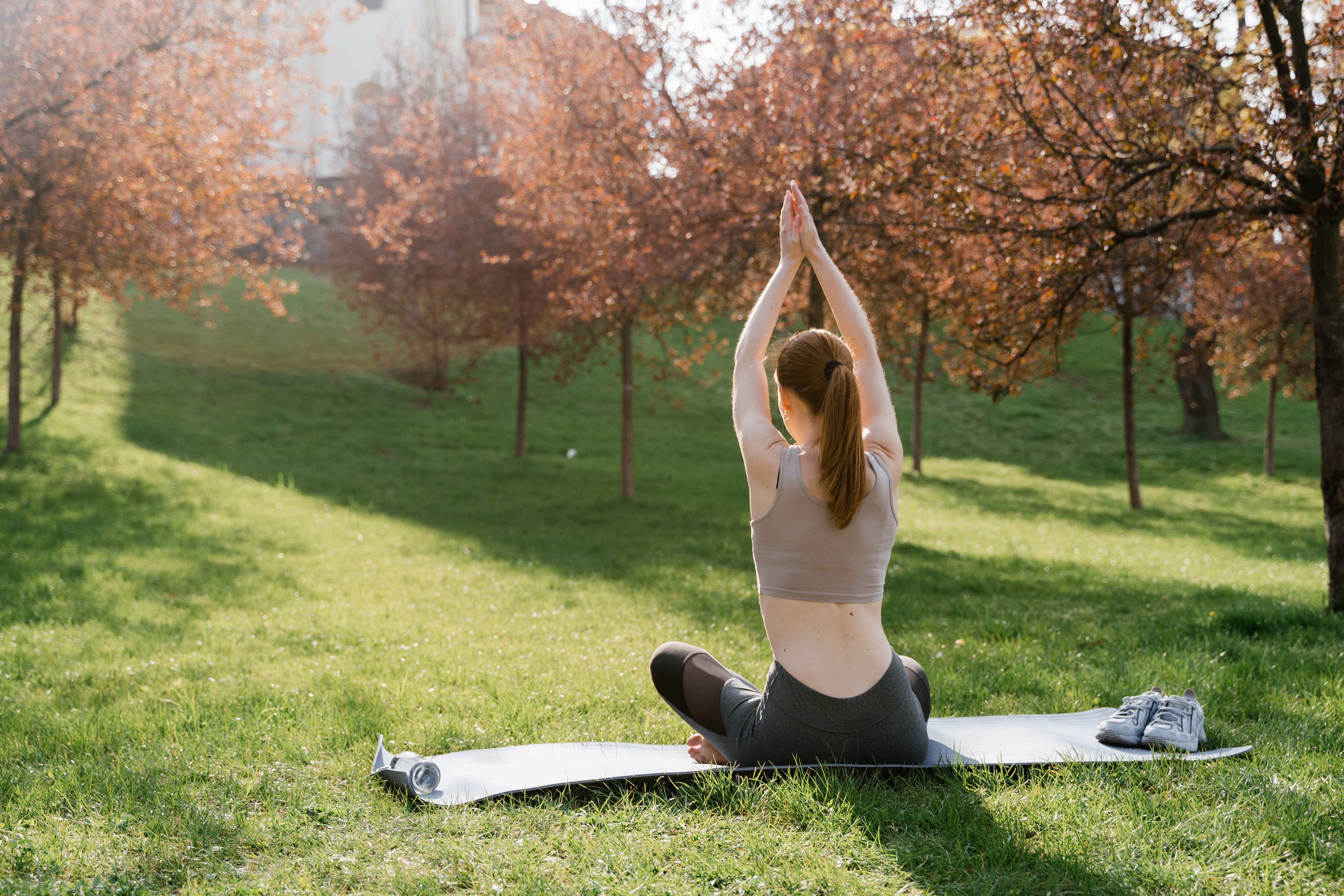 This photo demonstrates a woman doing yoga outdoors during autumn.